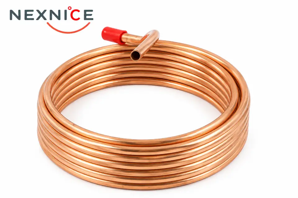A soft copper coil with a red-capped end on a white background, showing the bright tube surface and open bore.