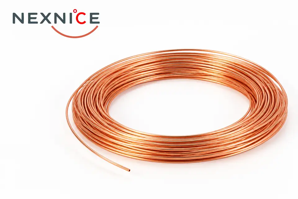 Copper capillary tubing coil on a clean white background.
