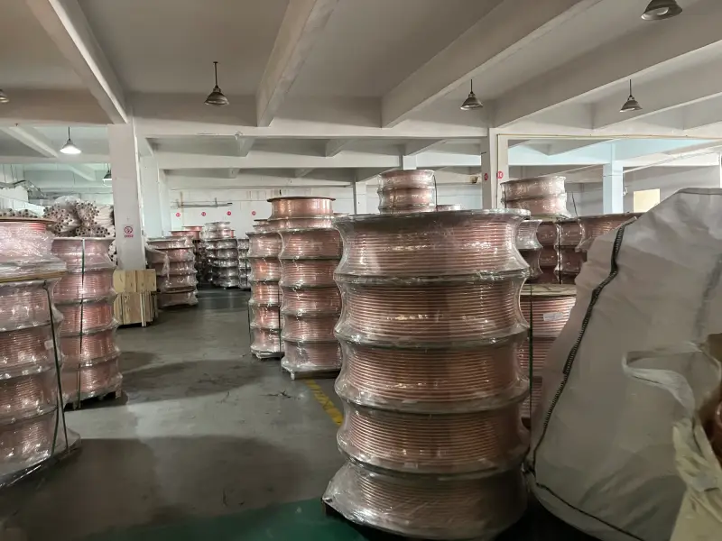 Bulk copper coils stacked in the warehouse of an insulated copper tube supplier factory
