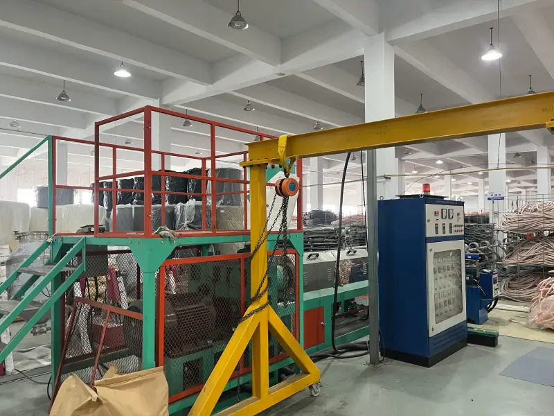 Yellow gantry crane over the insulated copper tube production line in a copper tube manufacturing factory