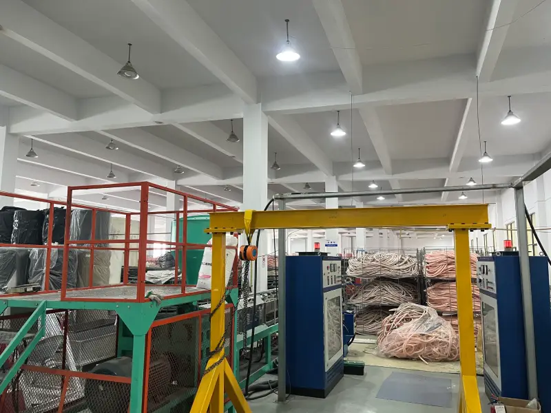 Gantry crane and production equipment inside an insulated copper tube factory workshop