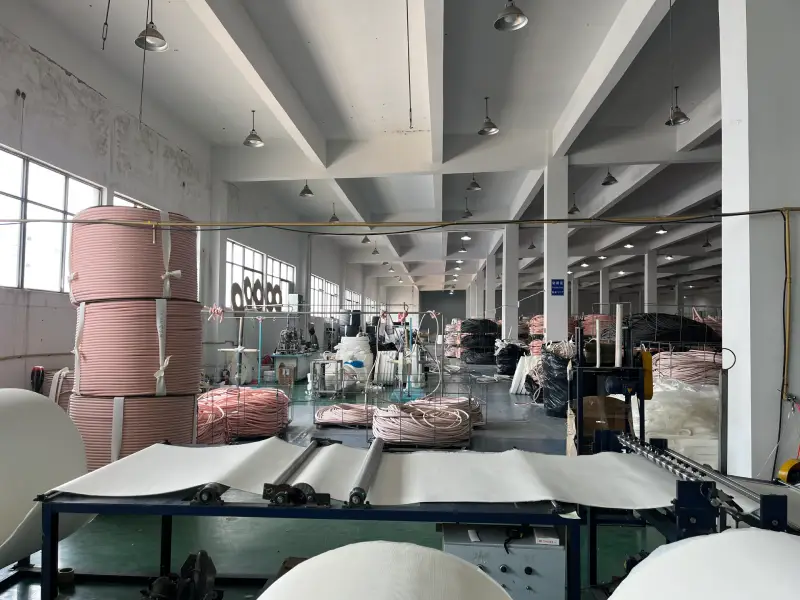 Workers cutting and inspecting insulated copper tube products in a copper tube factory workshop