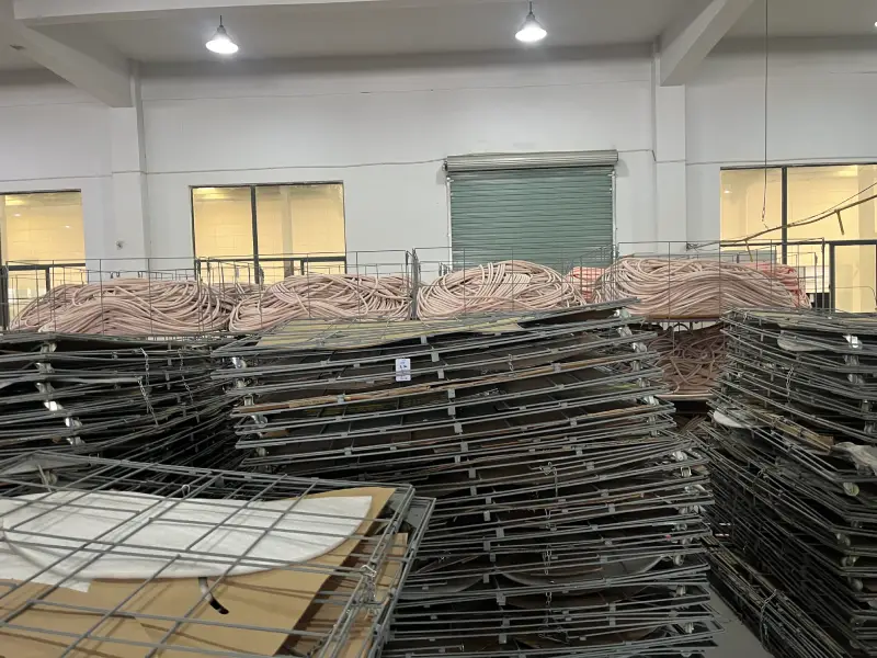 Wire storage cages filled with insulated copper tube coils in a copper tube factory workshop