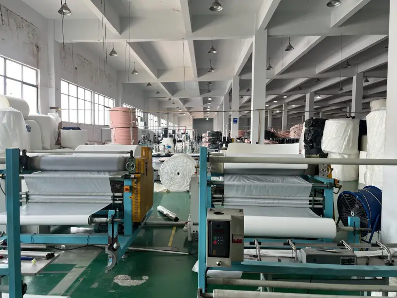 Row of laminating machines producing insulation material for copper tubes in a factory